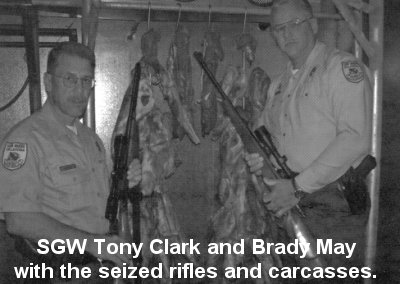 SGW Tony Clark and Brady May with the seized rifles and carcasses.